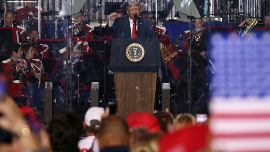 US President Donald Trump raises a fist as he speaks during the kick-off celebration for the "Great American State Fair" on the National Mall in Washington, DC, to celebrate the 250th anniversary of US independence