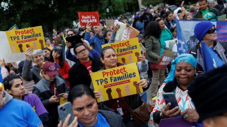 Demonstrators chanted and held signs outside the US Supreme Court as it weighed ending temporary protected status for Haitians and Syrians