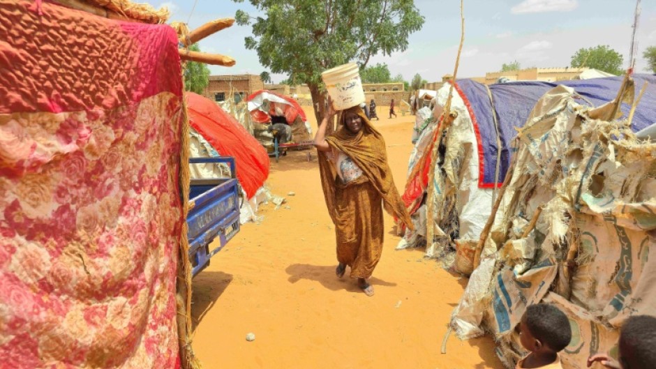 Displaced residents of southern Kordofan must walk long distances to find water during fighting between the government army and the paramilitary Rapid Support Forces