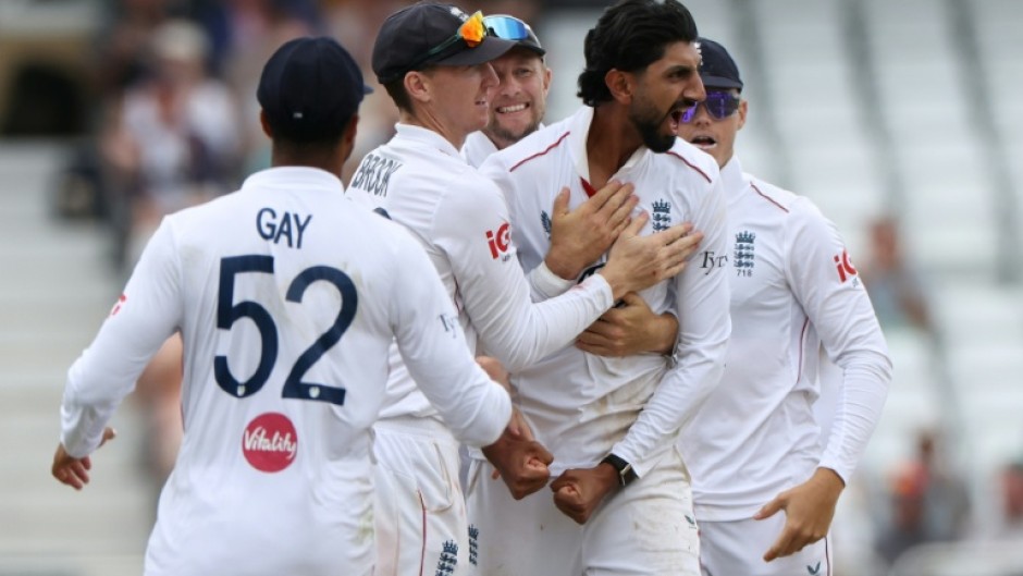 England off-spinner Shoaib Bashir (2R) celebrates with teammates after trapping New Zealand's Rachin Ravindra lbw in the third Test at Trent Bridge