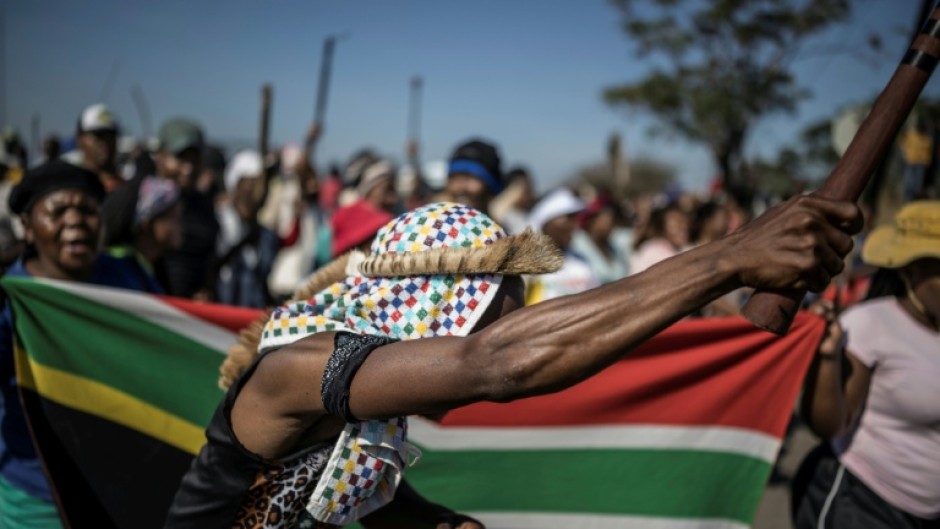 Protests have been fronted by men carrying sticks and shields