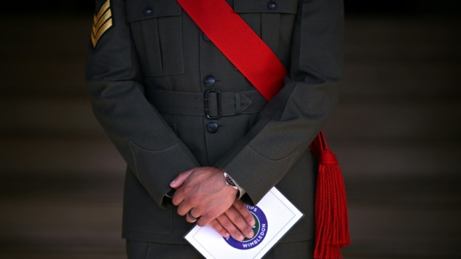 A member of the military stands guard on the first day of the 2026 Wimbledon Championships