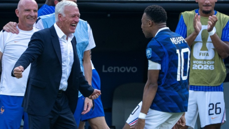 Kylian Mbappe celebrates with France coach Didier Deschamps