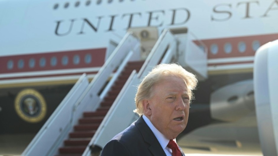 President Donald Trump speaks to the press before he boards Air Force One for his first flight aboard the Boeing 747-8 that Qatar gifted to the United States
