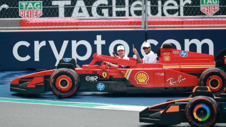 Charles Leclerc drives with Lewis Hamilton a passenger in a Lego Ferrari in Miami in May