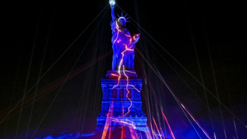 The Statue of Liberty is illuminated during the "Liberty Lights" event celebrating the 250th anniversary of US independence
