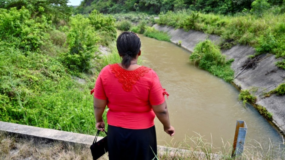 Eva Sevillano, a resident of the Nueva Prosperina neighborhood of Ecuador's port Guayaquil, stands at the waterway known as the Canal de la Muerte (Death Canal)