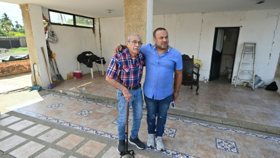 Engineer Elias Chayeb (L) and his son, engineer Elias Eduardo Chayeb, were relieved upon seeing a small residential building they helped build had withstood the two violent earthquakes in Venezuela