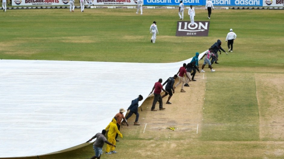 Ground staff pull on the covers during the fifth and final day of the second Test between Sri Lanka and West Indies