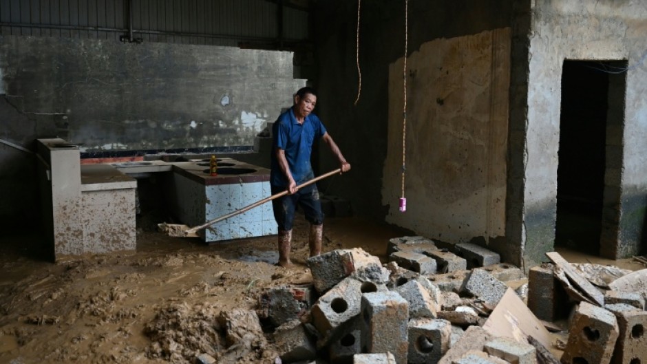 Residents of China's Liulan began the long process of cleaning up their wrecked homes after devastating storms
