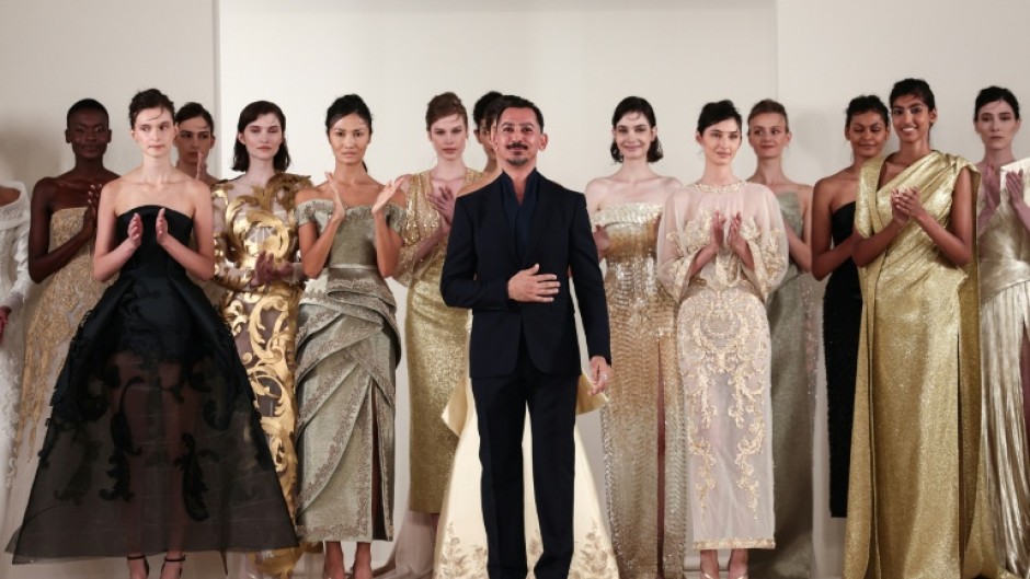 Syrian fashion designer Rami Al Ali with models at the end of his show