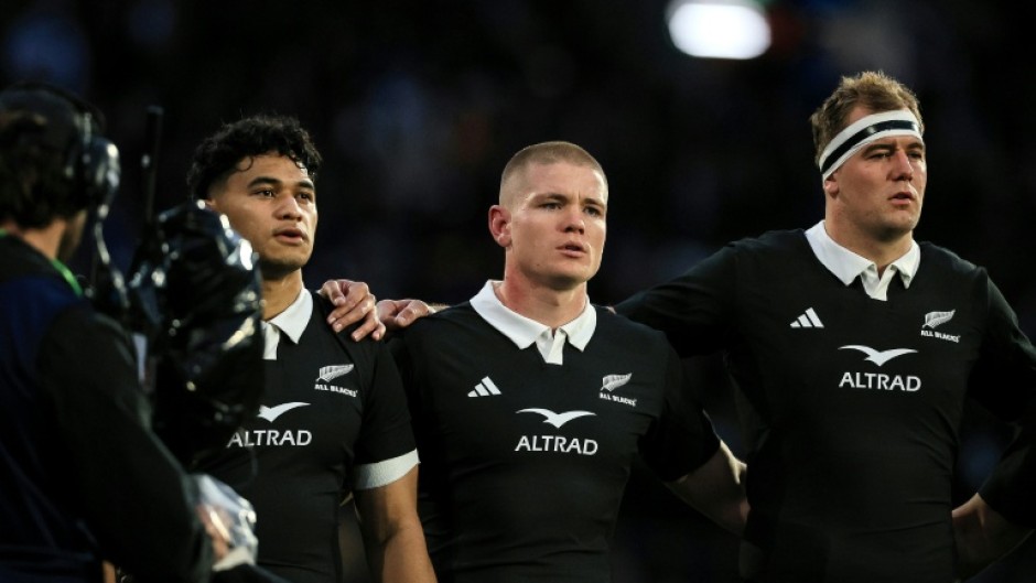 German-born Anton Segner (centre) sings the national anthem as he lines up with fellow All Blacks Wallace Sititi (left) and Sam Darry before the Nations Championship match against Italy in Wellington