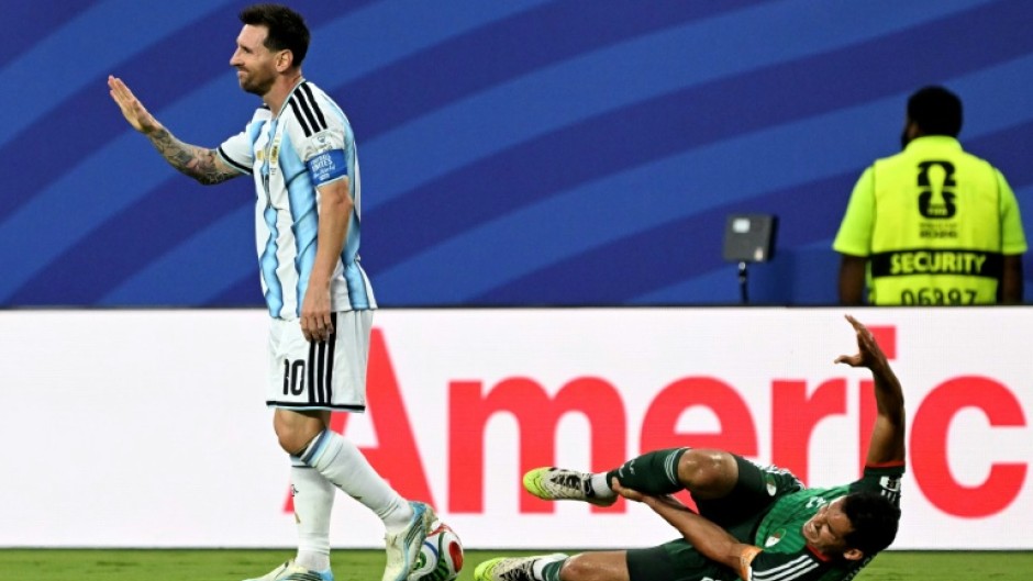 Argentina forward Lionel Messi gestures after fouling Algeria's Aissa Mandi, which pundits say should have earned him a red card