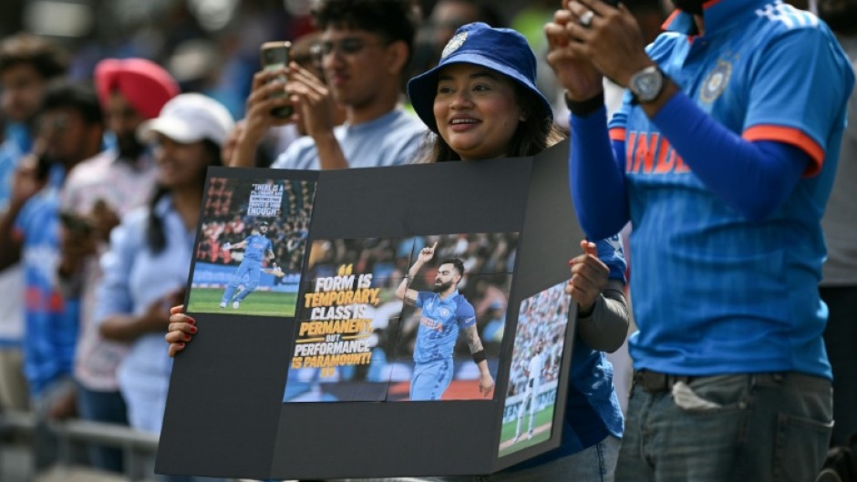 India fans watch as the team take to the field before the start of the first one-day international (ODI) cricket match against England at Edgbaston in Birmingham, central England