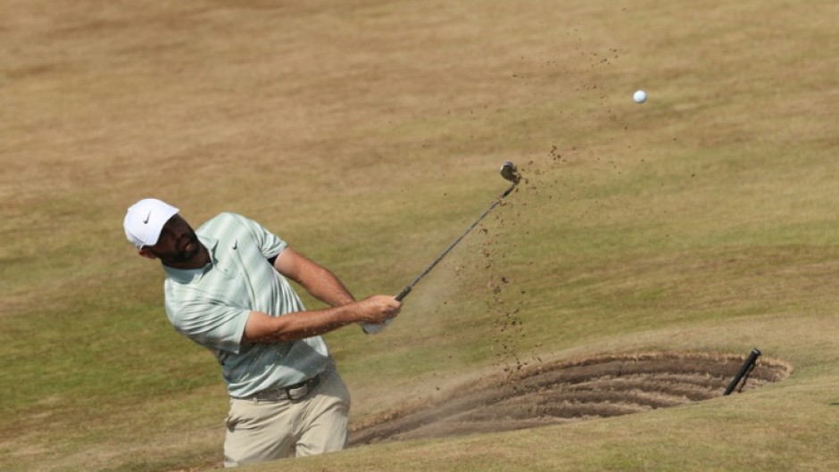 Scottie Scheffler plays from a bunker during practice for the British Open at Royal Birkdale