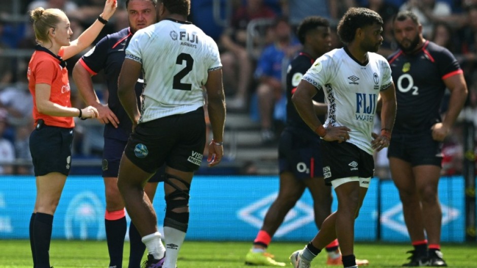 Referee Hollie Davidson shows a red card to Fiji's scrum-half Simione Kuruvoli (right) during the Nations Championship match against England