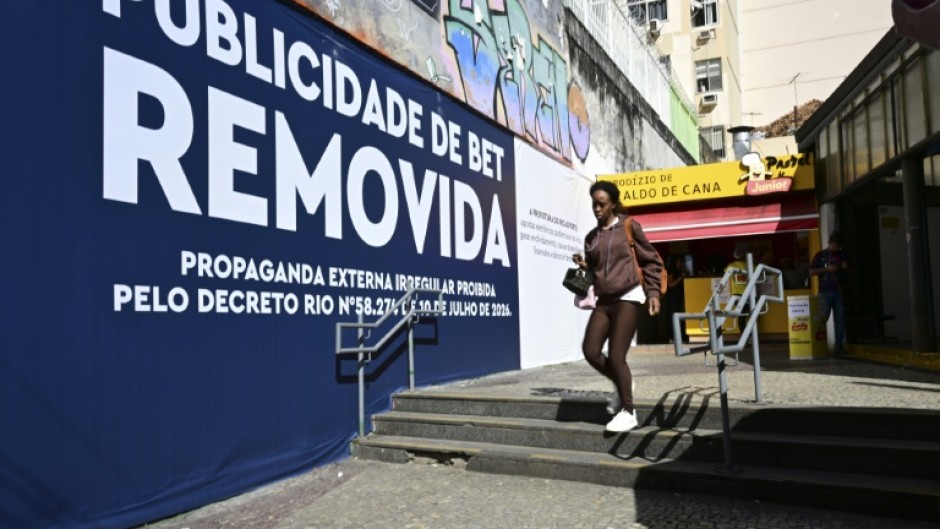 Rio de Janeiro municipal workers went through the streets this week covering up billboards with the message: 'Betting ad REMOVED'