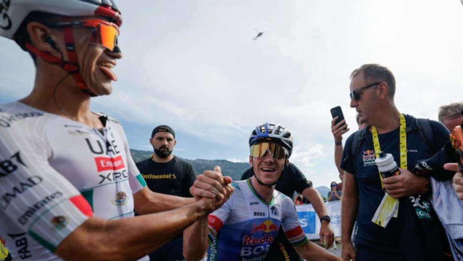 A leaner meaner Remco Evenepoel (C) has proved he can mix it with the best climbers at the Tour de France