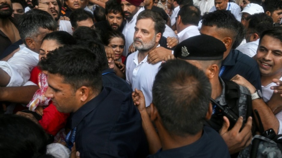Security personnel detain Indian opposition leader Rahul Gandhi (C) during a protest outside Prime Minister Narendra Modi's residence in New Delhi on Tuesday