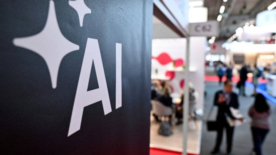 People walk past a banner for AI at the 2024 Frankfurt book fair