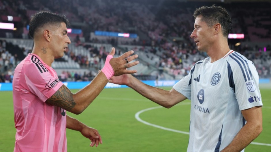 Luis Suarez of Inter Miami (left) and Robert Lewandowski of Chicago Fire after Miami's win