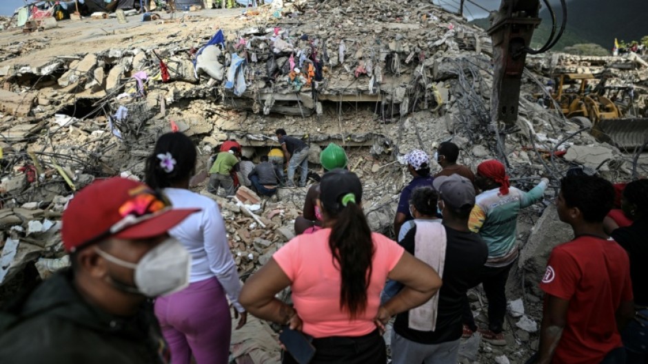 People search for bodies amid the rubble of a building in Caraballeda, Venezuela, on July 22, 2026