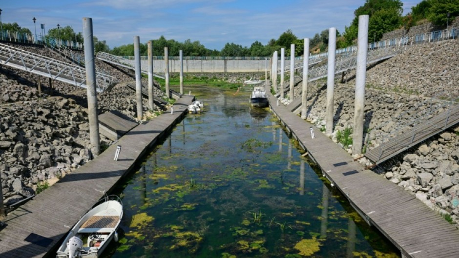 Boats stranded in shallow water in the tourist port in Corabia, southern Romania