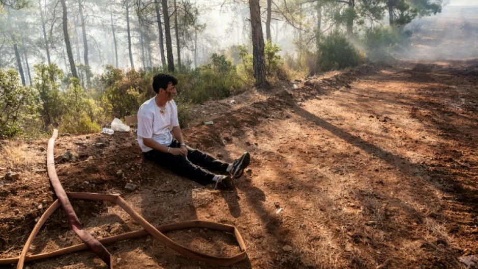 A volunteer rests amid operations to tackle a wildfire in Fethiye, southwest Turkey