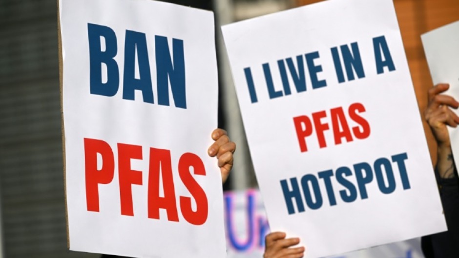 Environmental activists hold placards during a demonstration against PFAS chemicals next to the EU Commission headquarters in Brussels in March 2026