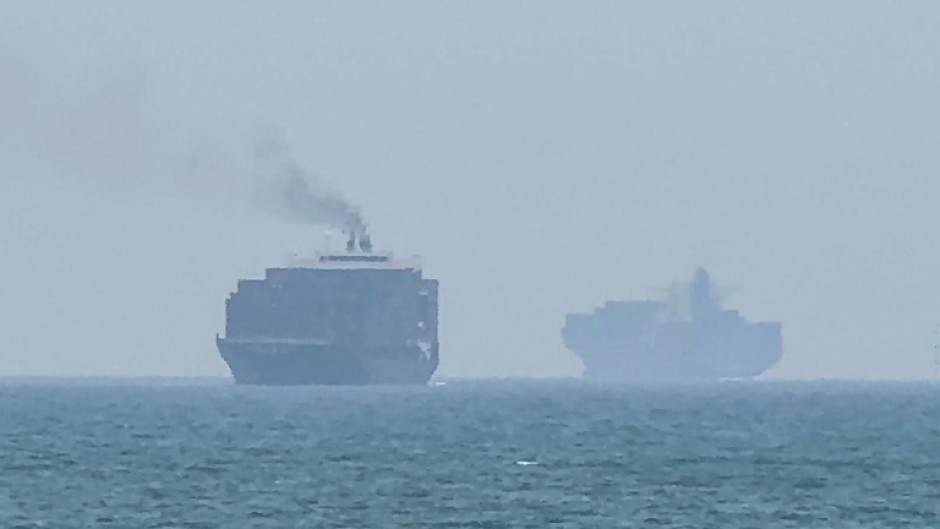 Cargo ships anchoring near the Strait of Hormuz off the eastern coast of the United Arab Emirates at Khor Fakkan