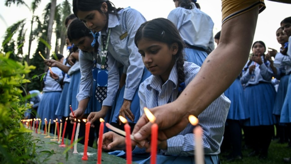 Mourners and students at Small Heaven School in Chitwan light candles after the death of mountaineer Nirmal Purja and his companions in an avalanche in Pakistan