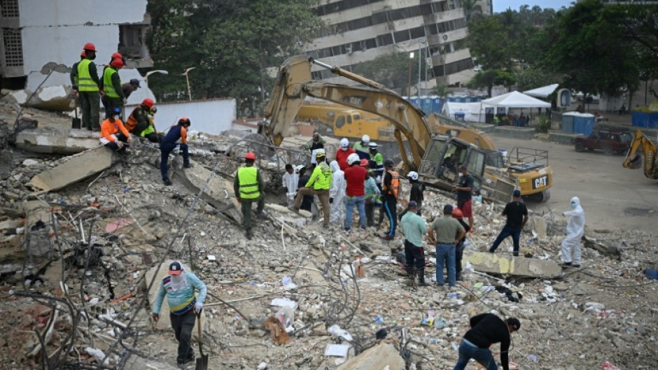 Rescue teams and volunteers search for bodies amid the rubble of a collapsed building in Caraballeda, Venezuela, on August 3, 2026