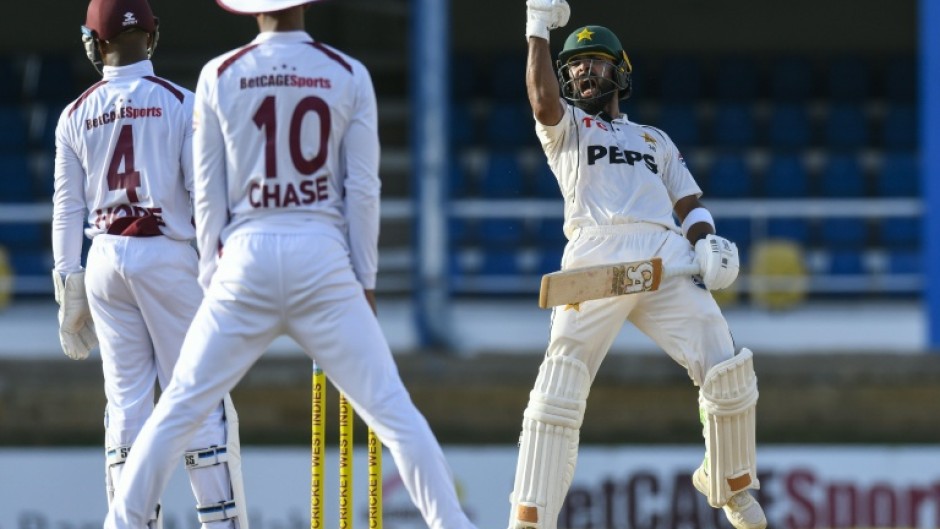 Pakistan batsman Abdullah Shafique (R) celebrates his century late on the second day against the West Indies