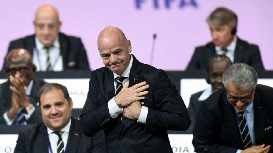 FIFA President Gianni Infantino (C) faces mounting problems after UEFA threatened legal action over his shelved plan