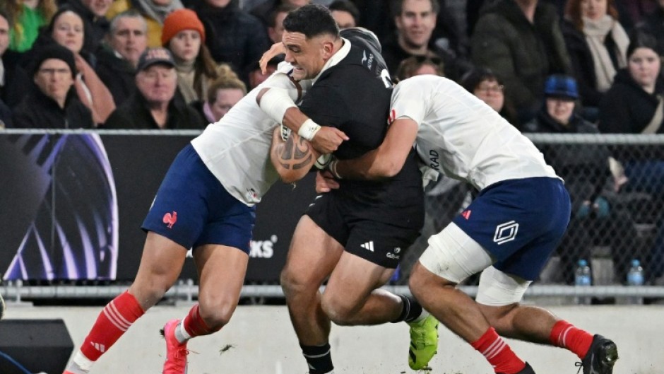 New Zealand hooker Codie Taylor (C) is tackled during a 2025 Test against France in Dunedin.