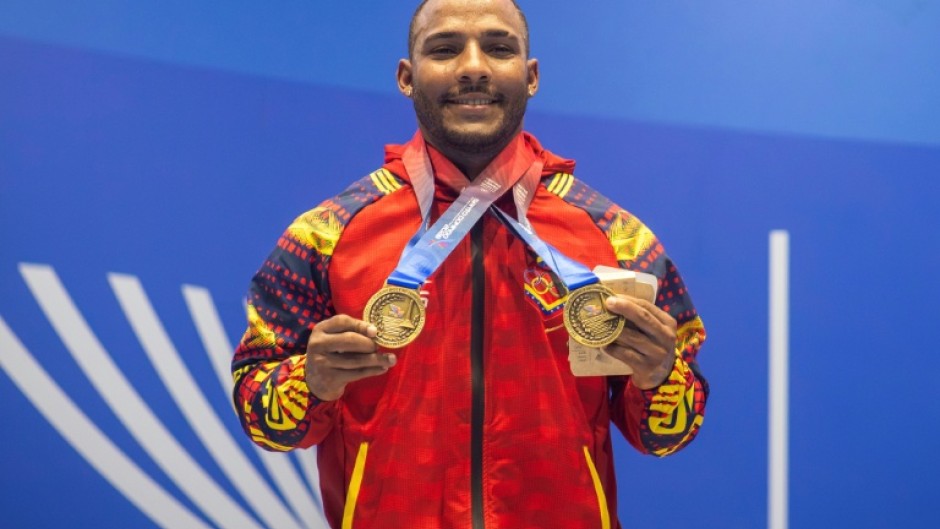 Venezuela's Julio Mayora, seen here in a handout picture from the Central American and Caribbean Games, carried cement blocks to rescue people following the twin earthquakes that struck Venezuela in June