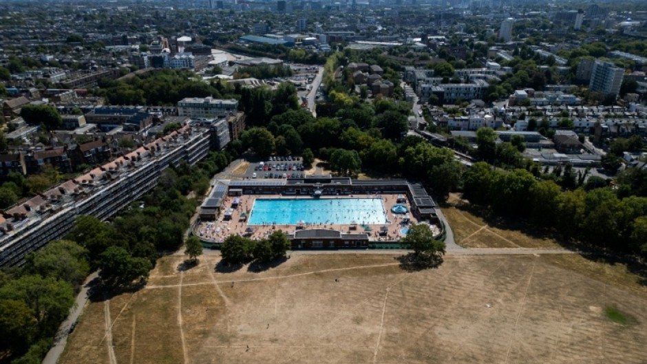 Swimmers use London's Parliament Hill Fields Lido, with the UK on course to record its warmest summer on record for the second year running