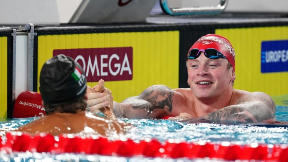 Adam Ramsay-Peaty (R) congratulates winner Nicolo Martinenghi of Italy