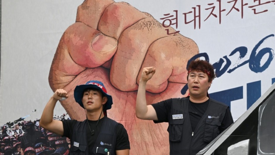 Members of the Korean Metal Workers' Union shout slogans during a joint strike rally in front of the Hyundai Motor headquarters in Seoul on August 21, 2026.