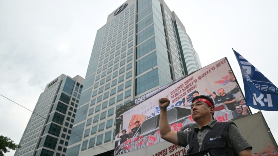 Members of the Korean Metal Workers' Union shouts slogans during a joint strike rally in front of the Hyundai Motor headquarters in Seoul on August 21, 2026.
