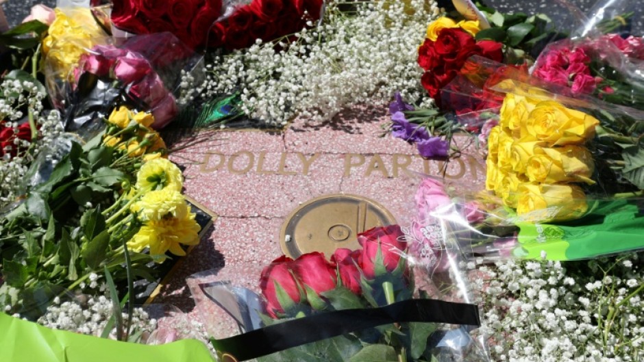 Flowers are seen on the Hollywood Walk of Fame Star of late US singer-songwriter Dolly Parton in the Hollywood neighborhood of Los Angeles on August 25, 2026.