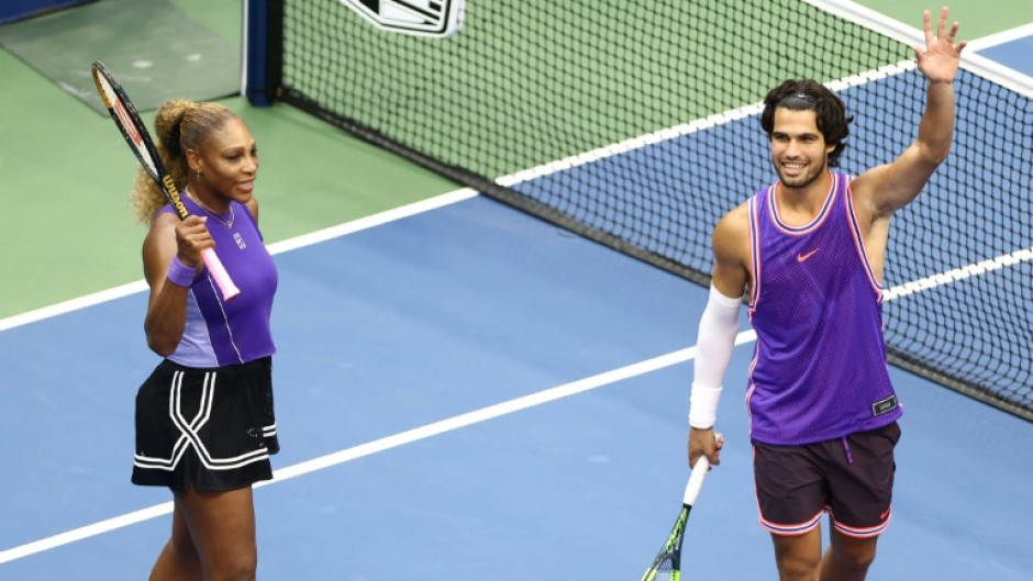 Serena Williams and Carlos Alcaraz salute the crowd after winning their mixed doubles opener at the US Open