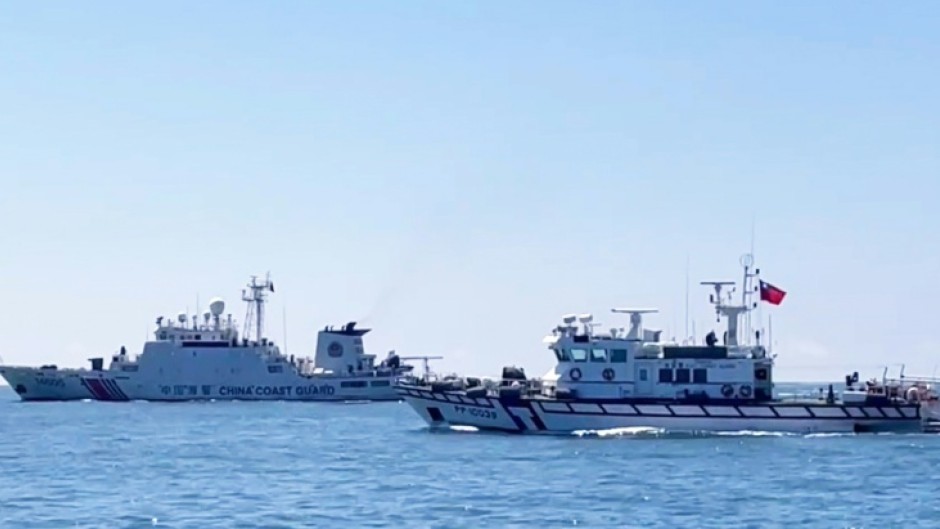 A Taiwan Coast Guard patrol vessel (R) sails near a China Coast Guard ship in waters south of Kinmen in July 2026