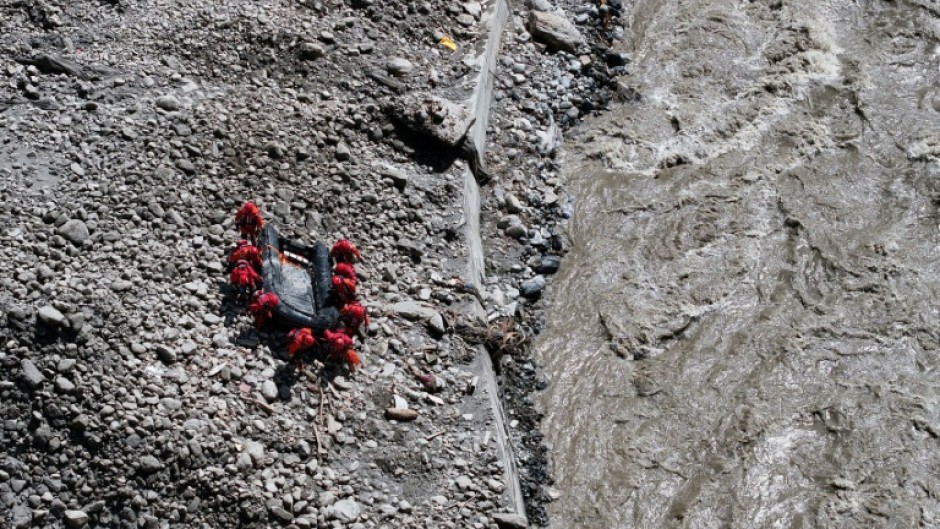 Fire and rescue personnel conduct search and rescue operations at Gyirong Port, which was destroyed by a mudslide two days earlier, in Gyirong County, in China’s western Tibet region
