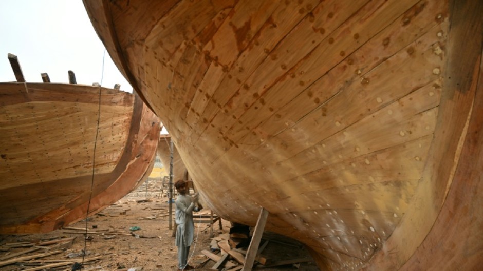 Workers in Ibrahim Hyderi town in Pakistan assemble handcrafted vessels timber by timber, despite the rise of industrial shipbuilding