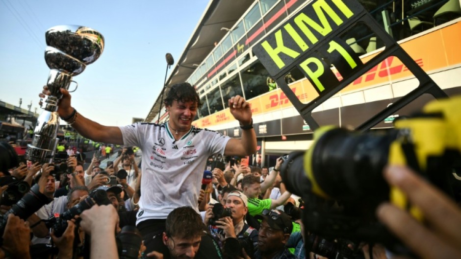 Kimi Antonelli celebrates with with his Mercedes team after coming from 19th on the grid to win the Italian GP