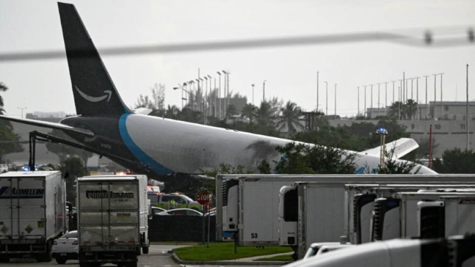 The tail section of a cargo plane is seen at Miami International Airport after it overshot the runway