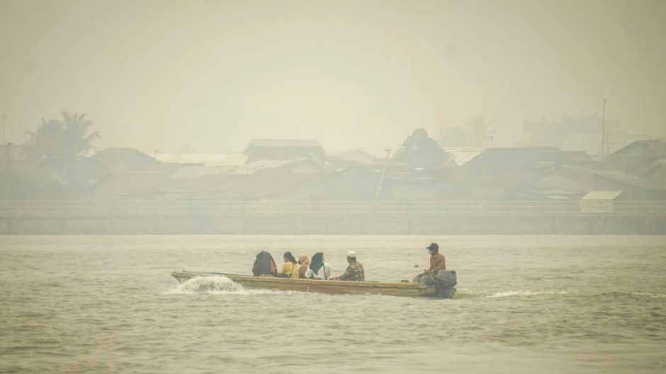 Indonesians on Borneo island say they acrid yellow haze has damaged their health
