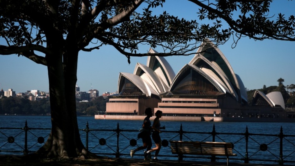 People run past the Sydney Opera House on the first day of spring in Sydney on September 1, 2026
