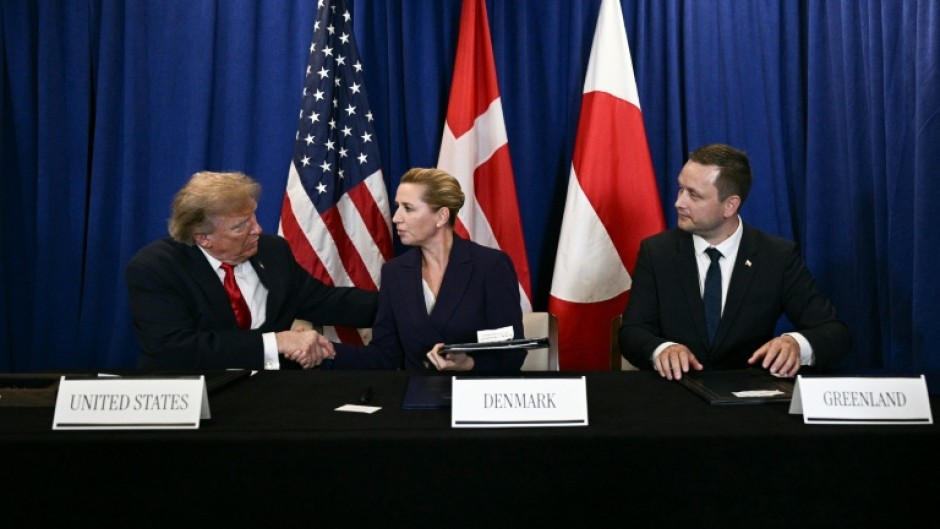 US President Donald Trump signs a security deal with Denmark's Prime Minister Mette Frederiksen and Greenland's Prime Minister Jens-Frederik Nielsen
